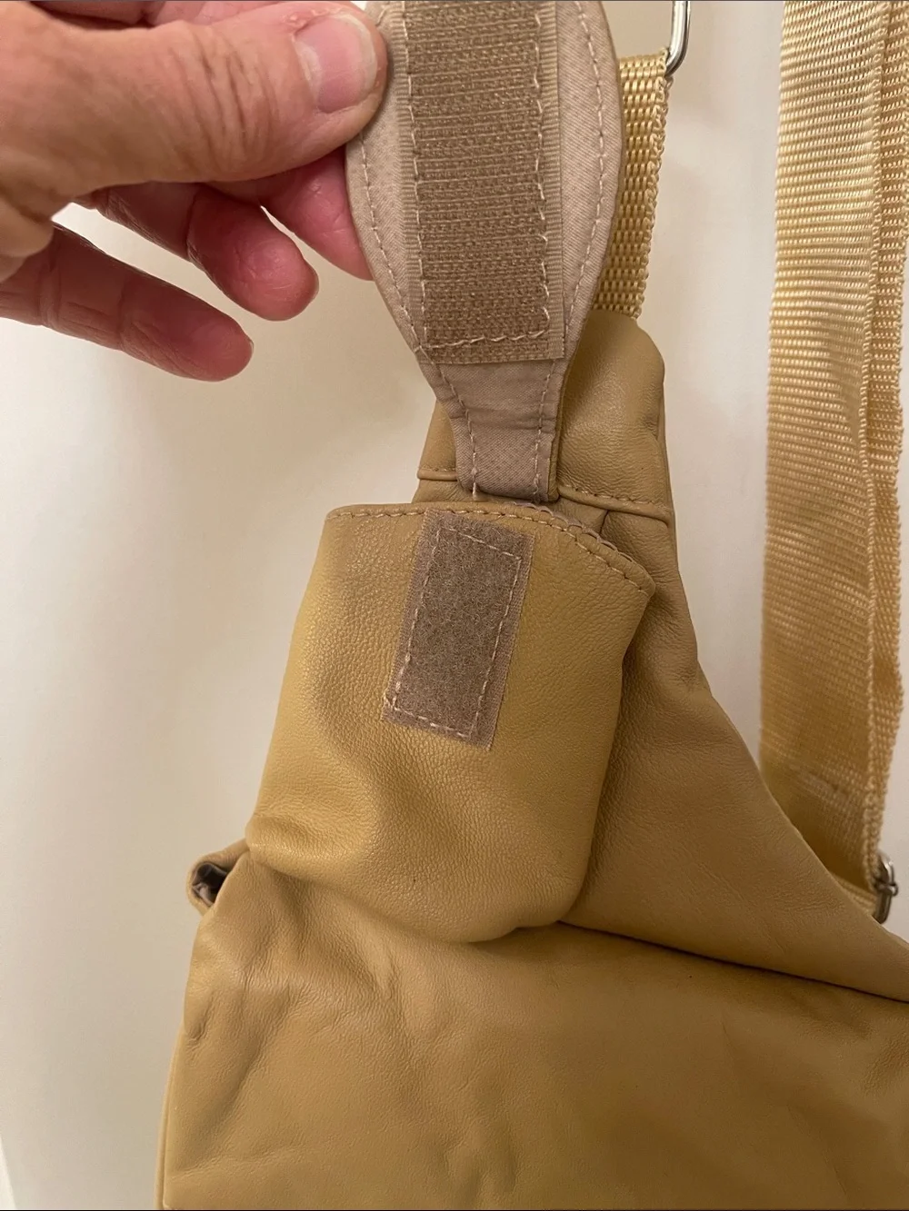 Buxton tan crossbody sling backpack
